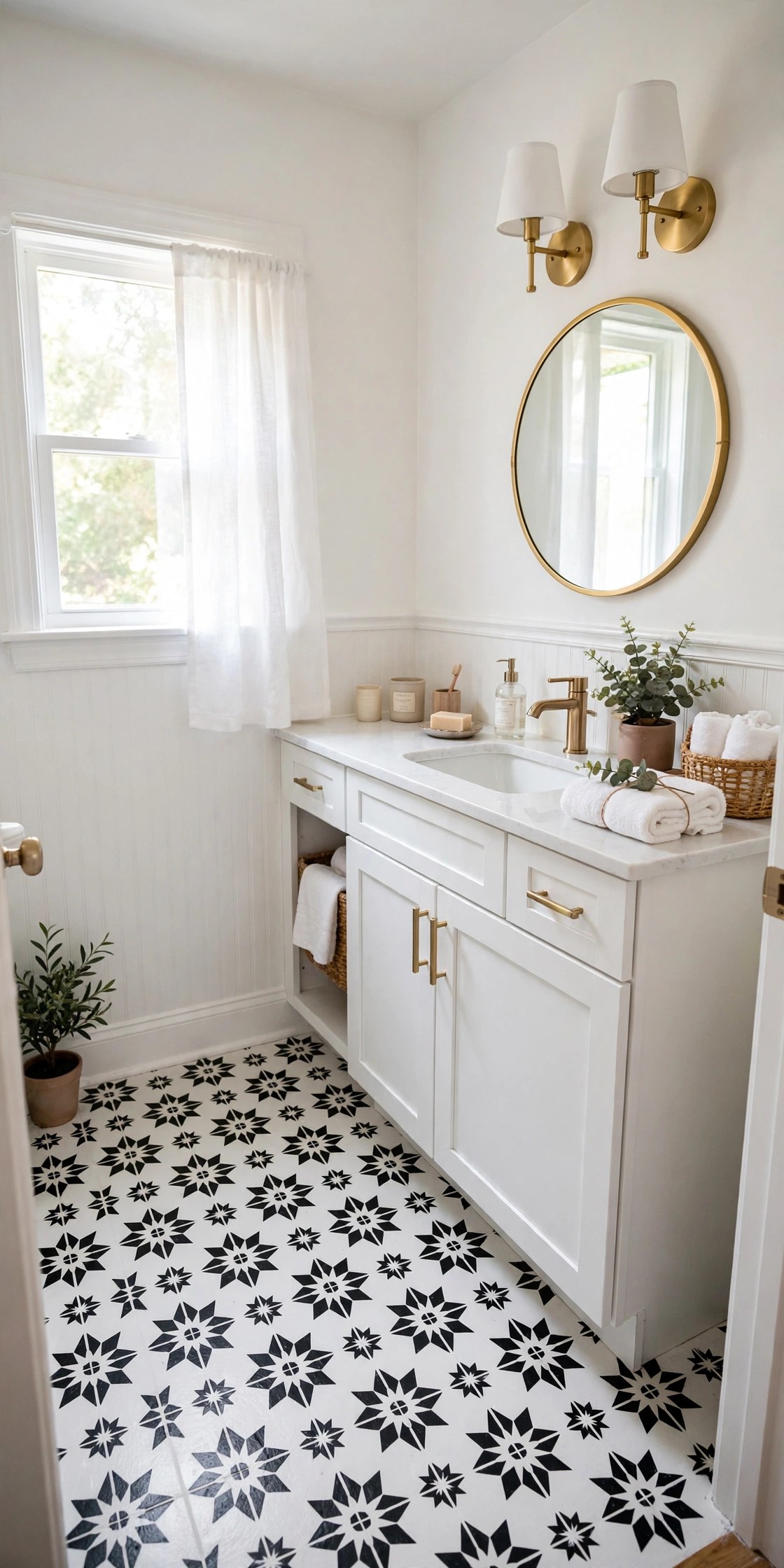 Small bathroom with black-and-white stenciled painted tile floor, white vanity, bright walls